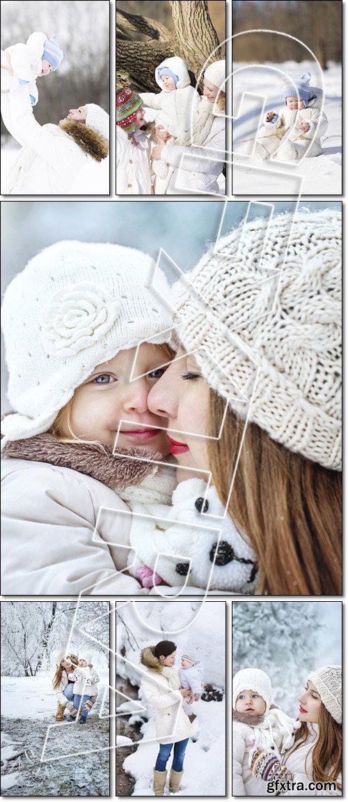 Young mother and her baby playing in the snow - Stock photo